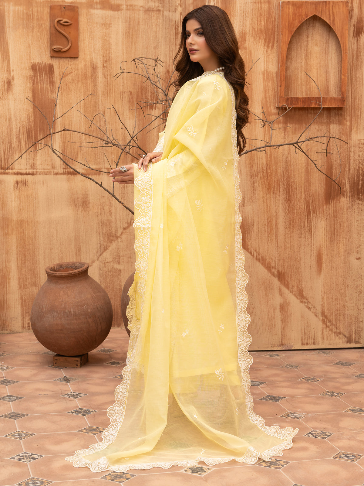Close-up of embroidered neckline on lemon yellow suit