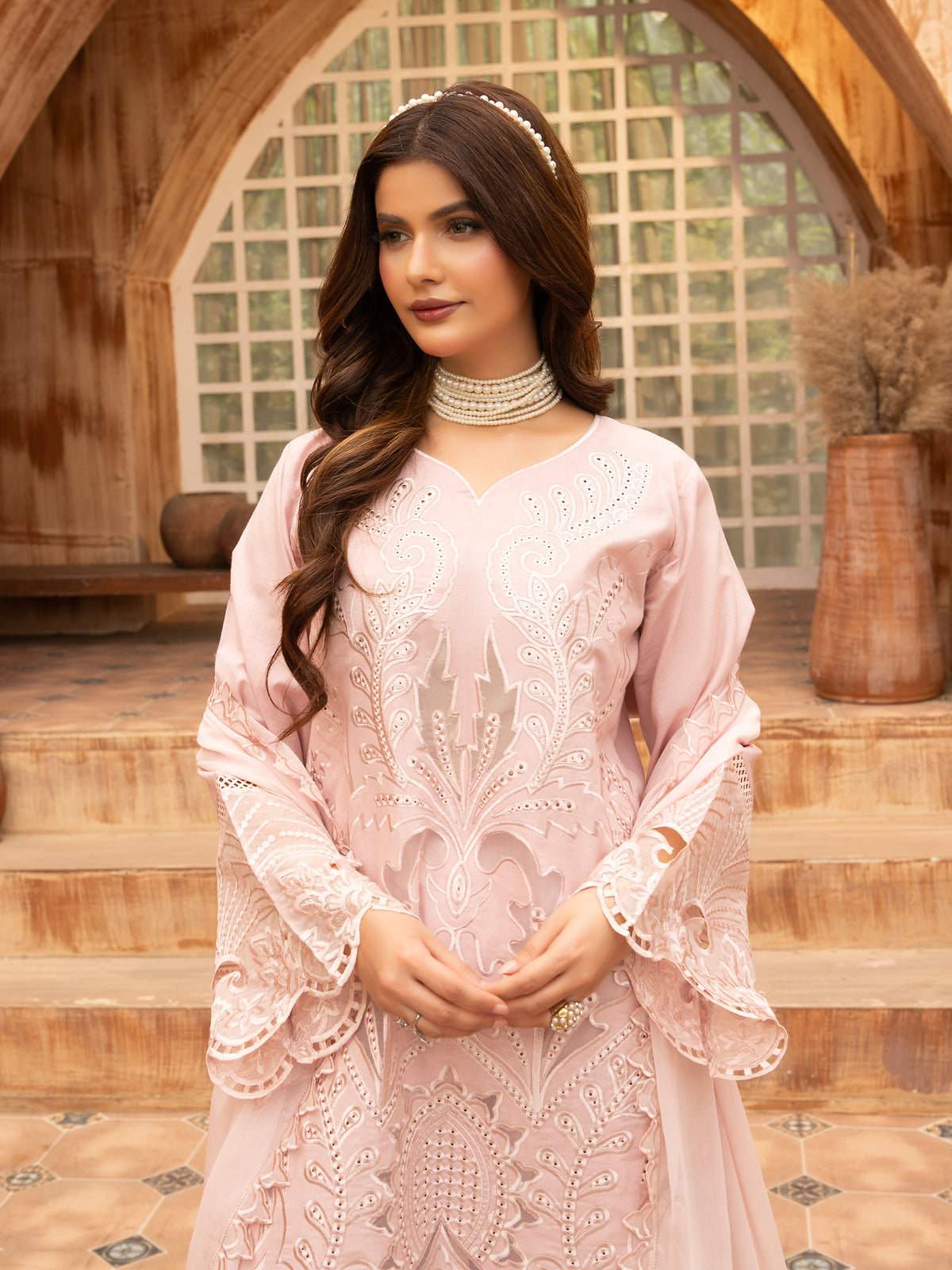 Full-length front view of pink embroidered lawn suit with scalloped hem