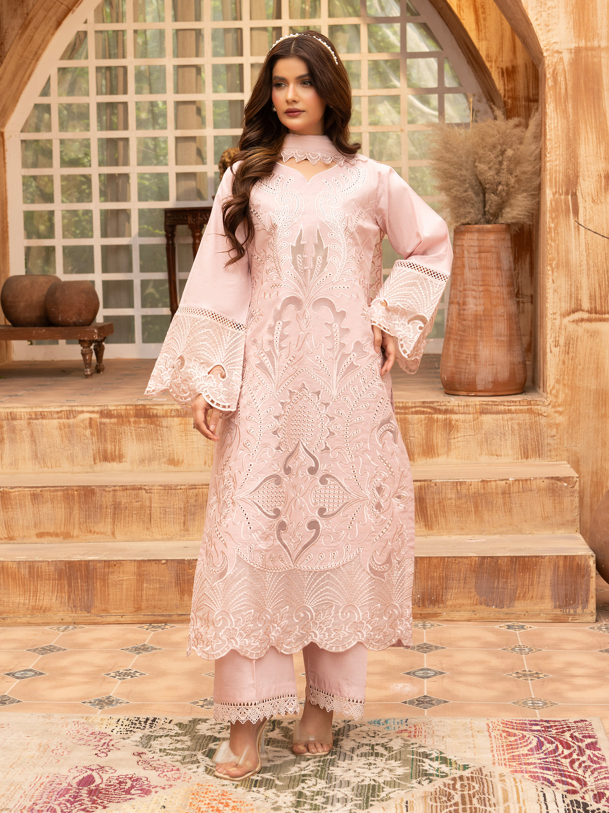 Front view of light pink embroidered lawn suit with pearl accessories