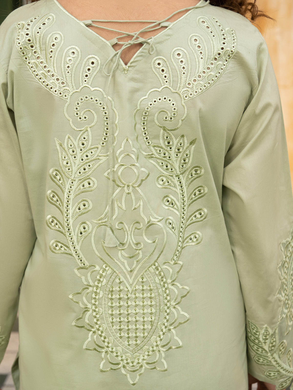 Close-up of embroidered neckline on pista suit